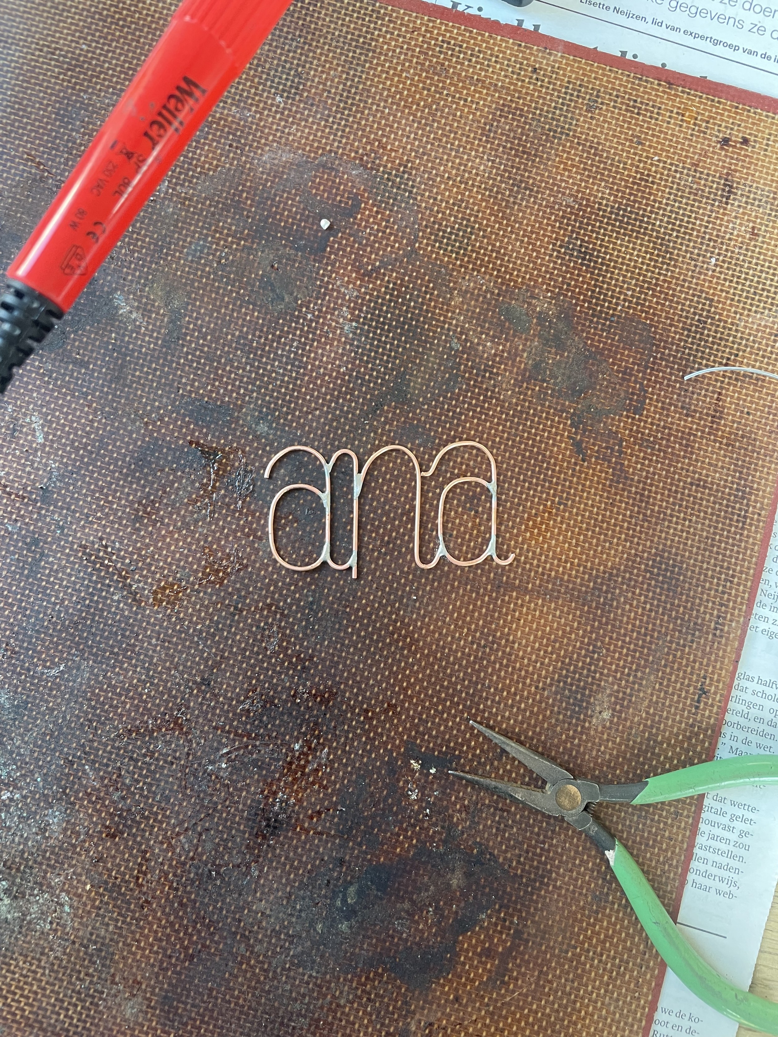 A soldered set of letters, spelling out “ana”.