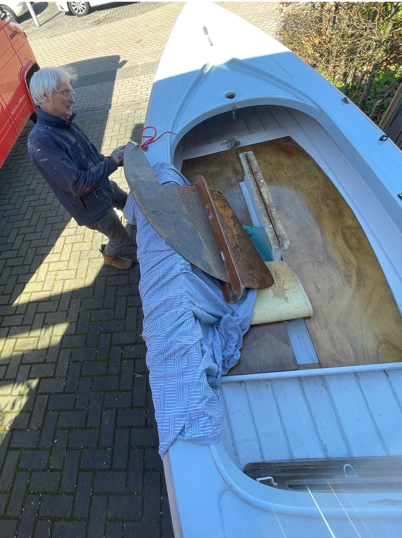 The sword lies on some mats in the boat.