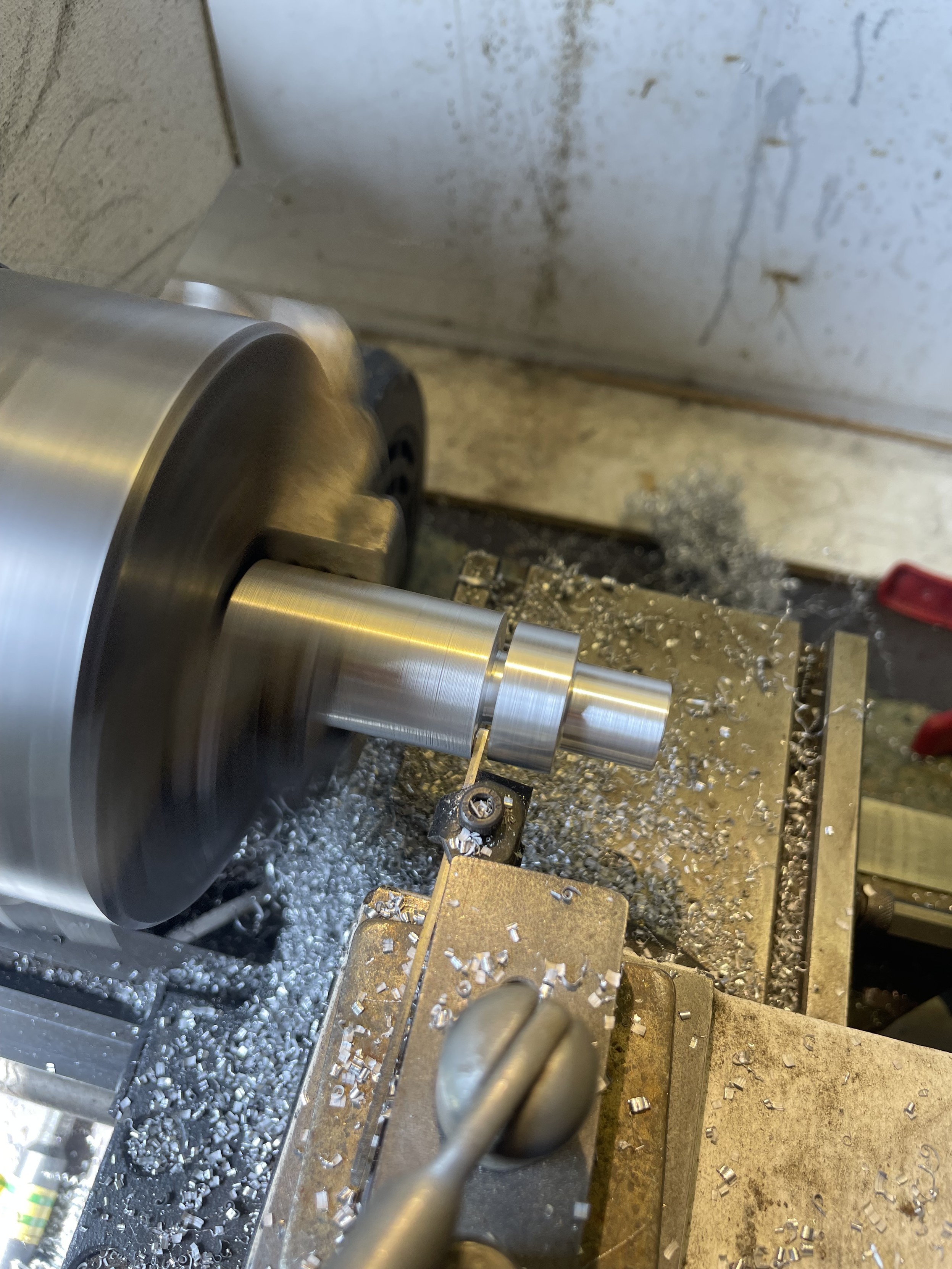 spinning lathe head with the piece being in the process of parting off