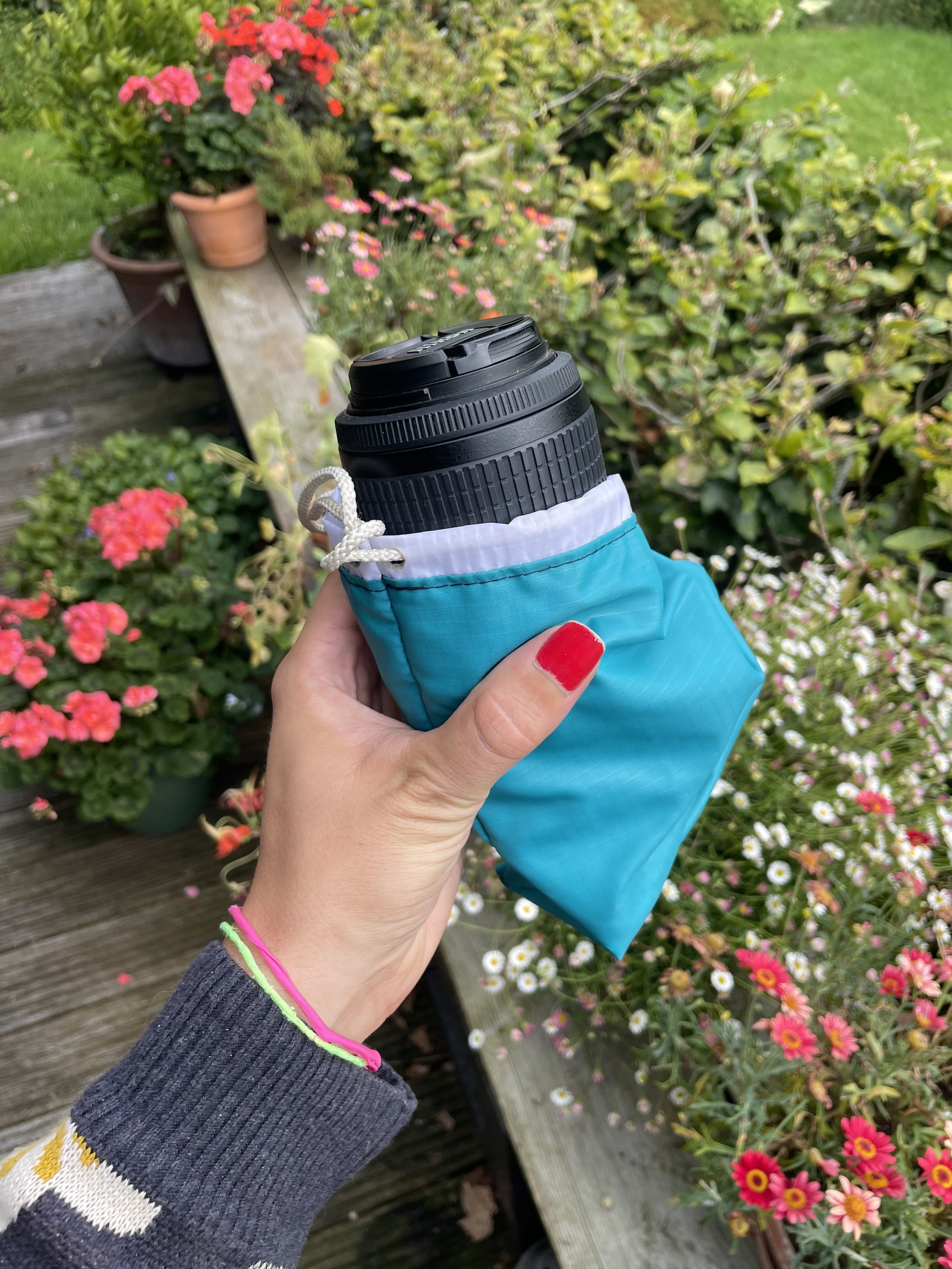 A lens poking out of a small pouch. I’m holding it in my hand.