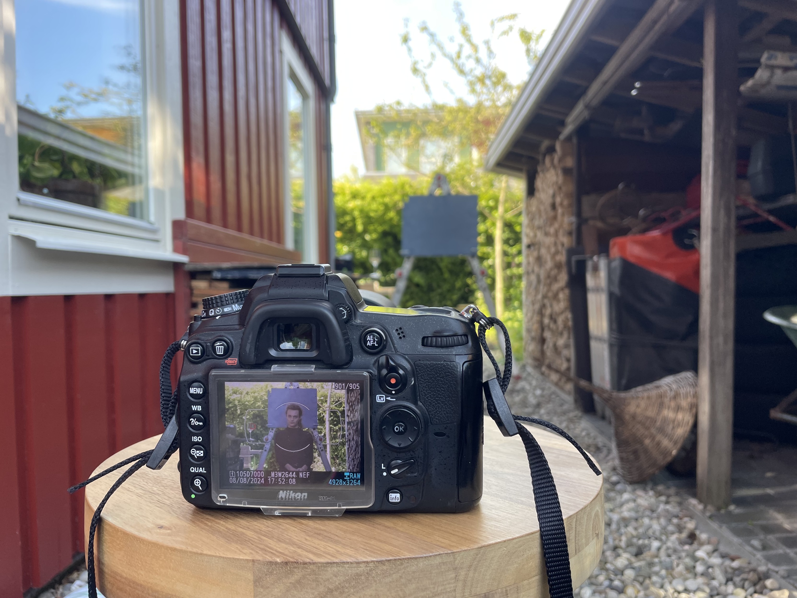 My camera in the foreground with the latest picture displayed. In that picture is me, looking at the camera. In the background, you can see the set.