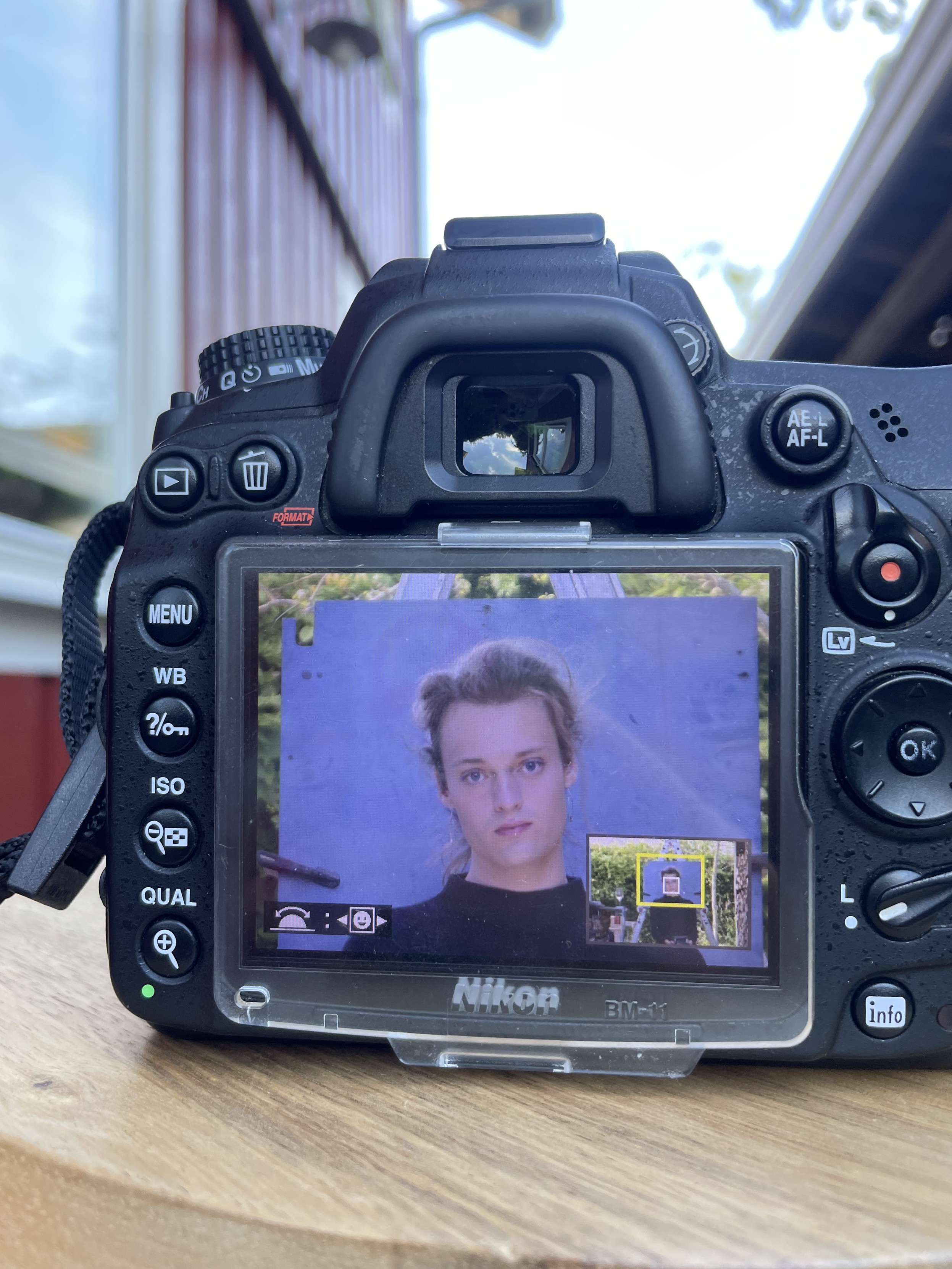 Picture of a photo displayed on the camera. It’s a portrait of me against a soft blue background. 
