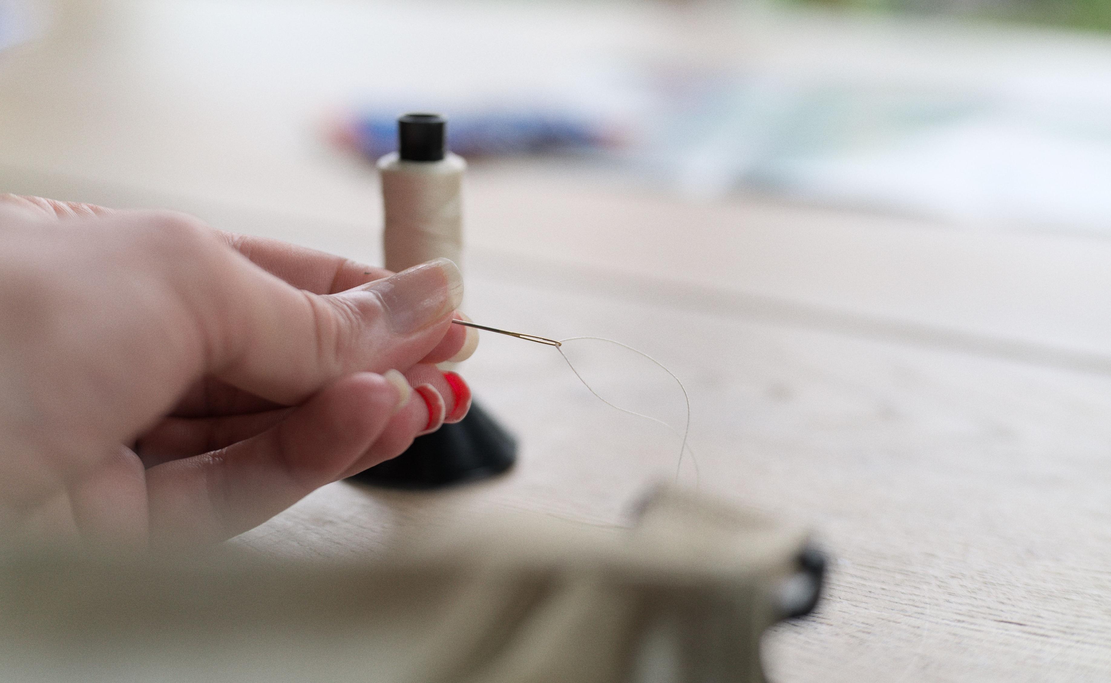 Threaded needle.