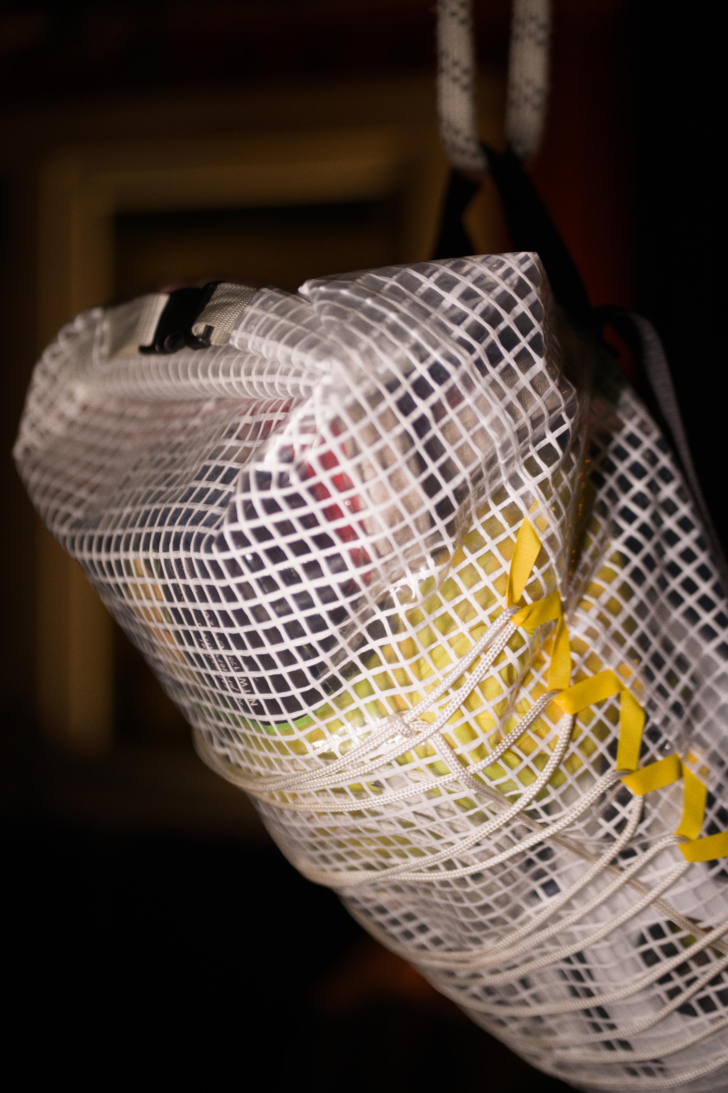 View of the other side, with some detail on the roll-top push-clip closure, which is attached to the bag with white webbing.